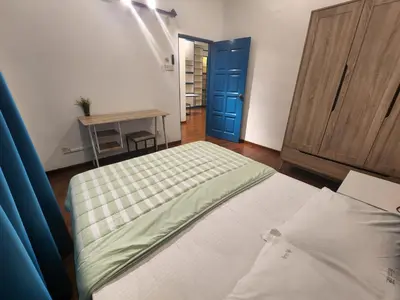 a bedroom with a bed and a blue door at Gurney Vacation Gathering Comfy Home - Solok Burma in George Town