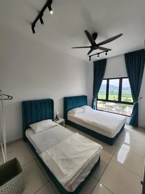 a bedroom with two beds and a ceiling fan at Horizon Rooftop Skypool Condotel - Ipoh in Ipoh