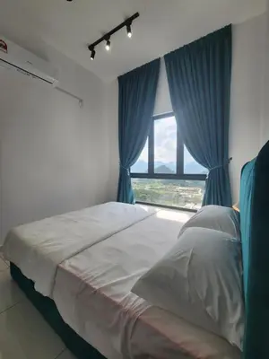 a bedroom with a bed with blue curtains and a window at Horizon Rooftop Skypool Condotel - Ipoh in Ipoh