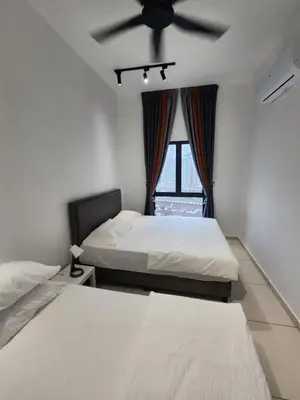 a bedroom with two beds and a ceiling fan at Horizon Rooftop Skypool Condotel - Ipoh in Ipoh