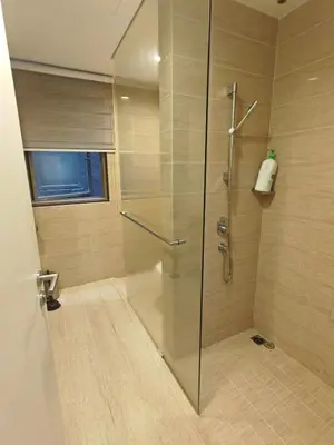 a shower with a glass door in a bathroom at By The Sea Fully Seaview all rooms Beach front in Batu Ferringhi