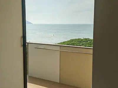 an open door with a view of the ocean at By The Sea Fully Seaview all rooms Beach front in Batu Ferringhi