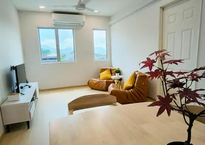 a living room with a table and a couch at Taiping town area - 3 bedroom in Taiping