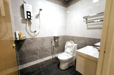 a bathroom with a shower and a toilet and a sink at Taiping town area - 3 bedroom in Taiping