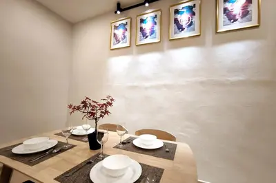 a dining room with a table with plates and wine glasses at Taiping town area - 3 bedroom in Taiping