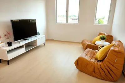 a living room with two chairs and a flat screen tv at Taiping town area - 3 bedroom in Taiping