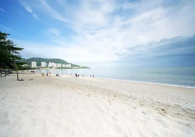 a group of people walking on a beach at Penang Rainbow Paradise in Tanjung Bungah