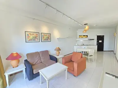 a living room with a couch and chairs and a table at Penang Rainbow Paradise in Tanjung Bungah