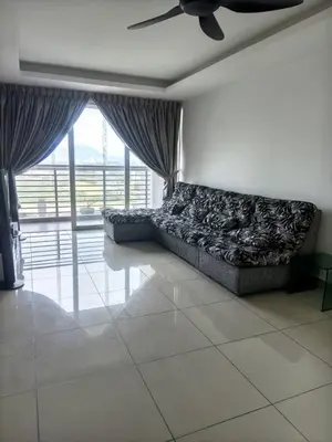 a living room with a couch in front of a window at Rainbow Apartment by Renuka in Butterworth