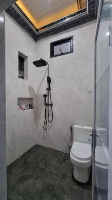 a bathroom with a shower and a toilet at Rainbow Apartment by Renuka in Butterworth