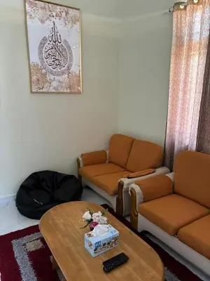 a living room with a couch and a coffee table at Airisafiq Homestay in Kampong Sungai Rambai
