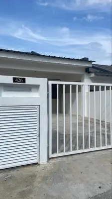 a garage door with a gate in front of a house at Raub Colonial Homestay in Raub