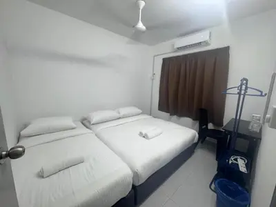 a bedroom with a white bed and a window at Raub Colonial Homestay in Raub