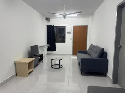 a living room with a couch and a tv at Raub Colonial Homestay in Raub