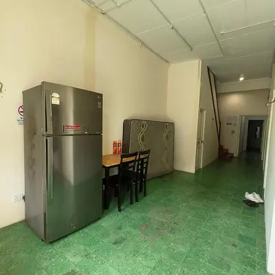 a kitchen with a refrigerator and a table with chairs at Affordable Nice and Comfortable Room in George Town