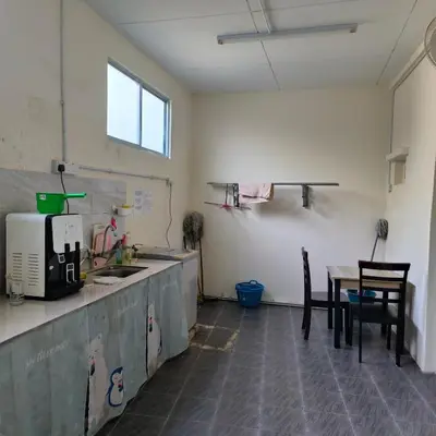 a kitchen with a counter and a table and chairs at Affordable Nice and Comfortable Room in George Town