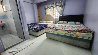 a small bedroom with two beds and a bathroom at PAS Homstay CH 2026 in Tanah Rata