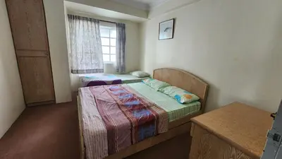a small bedroom with two beds and a window at PAS Homstay CH 2026 in Tanah Rata
