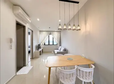 a living room with a wooden table and chairs at Wanderlust Retreat 1R by Iconic Regency in Bayan Lepas