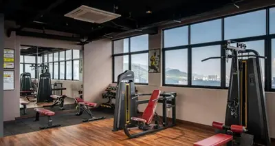a gym with treadmills and exercise equipment and windows at Wanderlust Retreat 1R by Iconic Regency in Bayan Lepas