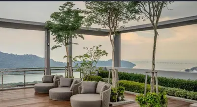 a living room with a view of the water at Wanderlust Retreat 1R by Iconic Regency in Bayan Lepas