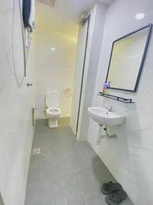 a bathroom with a toilet and a sink at Enviropath Hotel in Gua Sai