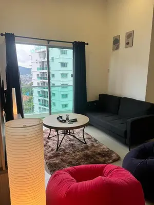 a living room with a couch and a table at Ayaan Snooker Home 5 at Quintet Apartment with Private Parking in Tanah Rata