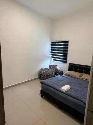 a bedroom with a bed in the corner of a room at Ayaan Snooker Home 5 at Quintet Apartment with Private Parking in Tanah Rata