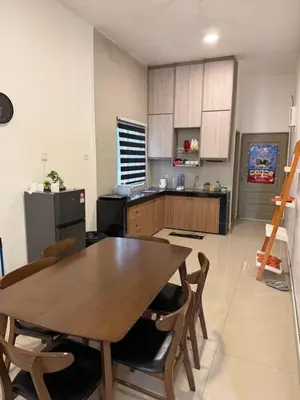 a large kitchen with a wooden table and chairs at Ayaan Snooker Home 5 at Quintet Apartment with Private Parking in Tanah Rata