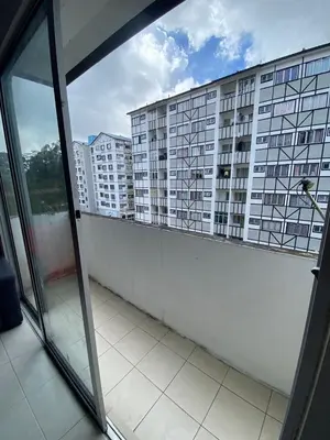 a view of a large building from a window at Rayyan'Homestay JAYA in Tanah Rata
