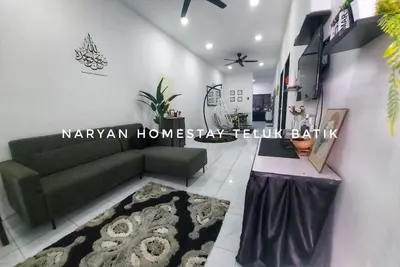 a living room with a couch and a table at Naryan Homestay Teluk Batik in Lumut