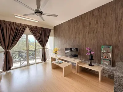 a living room with a couch and a television at The Nest Retreat, B7-3A-1 2BR Family Suite in Bukit Fraser