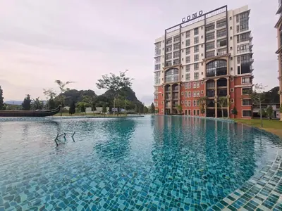 a swimming pool in front of a tall building at Seri Ipoh in Ipoh