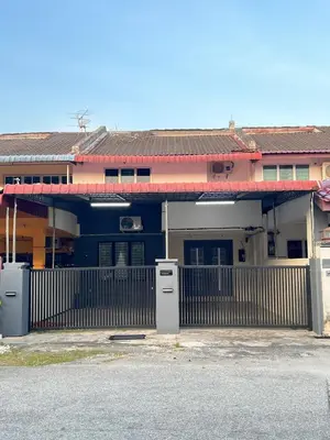 a house with a fence in front of a building at Classic Pearl Homestay in Teluk Intan