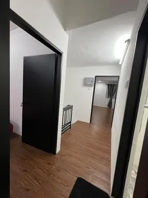 a room with a black door and a hallway at Classic Pearl Homestay in Teluk Intan