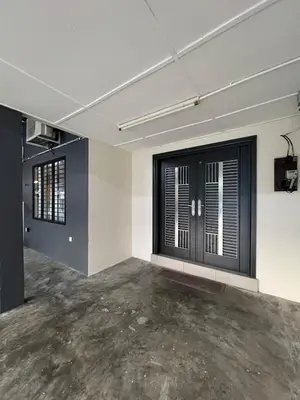 an empty room with black doors and a concrete floor at Classic Pearl Homestay in Teluk Intan