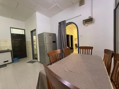 a kitchen and dining room with a table and chairs at Austin Taman Daya Large Corner House for 10 Pax in Gua Sai
