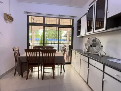 a kitchen with a table with chairs and a fan at Austin Taman Daya Large Corner House for 10 Pax in Gua Sai