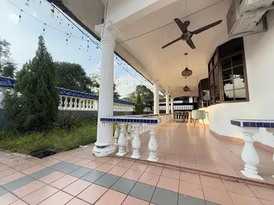 a porch with white columns and a ceiling fan at Austin Taman Daya Large Corner House for 10 Pax in Gua Sai