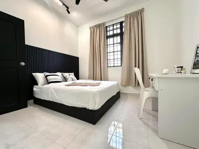 a bedroom with a bed and a desk and a window at Spacious Classic 4BR Family Haven I Simpang Ampat in Simpang Ampat
