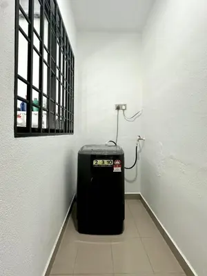 a room with a black heater in a white wall at Spacious Classic 4BR Family Haven I Simpang Ampat in Simpang Ampat