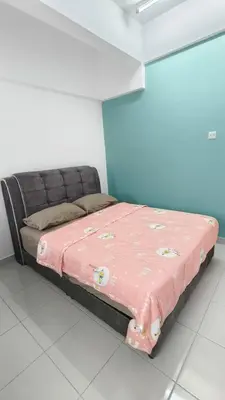 a bed in a room with a pink blanket on it at Hygge Living Kampar III Near UTAR in Kampar