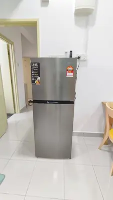 a refrigerator sitting on a floor in a room at Hygge Living Kampar III Near UTAR in Kampar