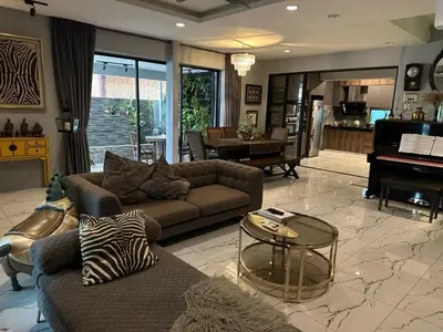 a living room with a couch and a piano at The Eve Homestay in Tanjung Bungah