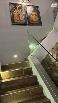 a set of stairs in a building with paintings on the wall at The Eve Homestay in Tanjung Bungah