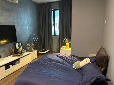 a bedroom with a bed with a teddy bear on it at The Eve Homestay in Tanjung Bungah