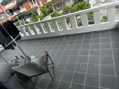 a view of a balcony with two chairs on a patio at The Eve Homestay in Tanjung Bungah