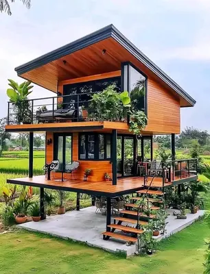 a house with a large deck with a balcony at Brian's Estate in Tanah Rata