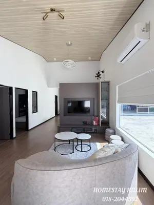 a living room with a couch and a tv at Stylish Landed Stay in Kulim