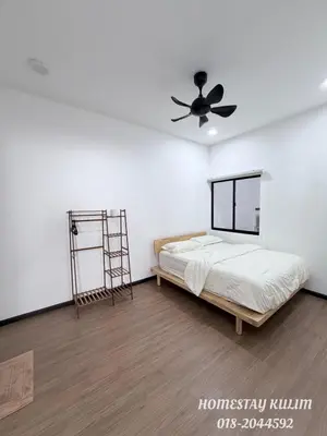 a bedroom with a bed and a ceiling fan at Stylish Landed Stay in Kulim